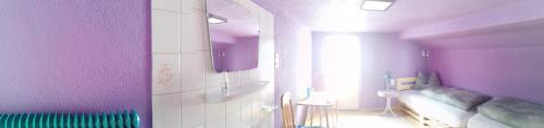 a purple room with a bed and a sink at sonnberg in Ischgl