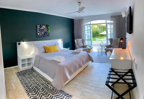 a bedroom with a large bed with a green wall at Vida Nova Retreat in Cape Town