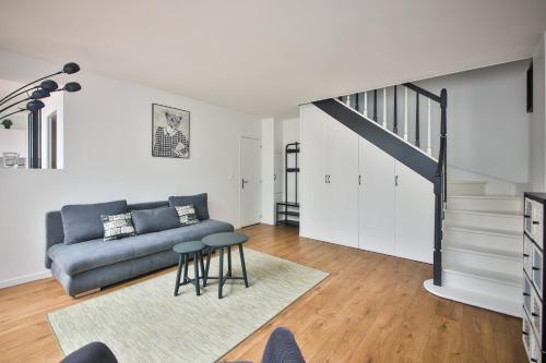 een woonkamer met een bank en een trap bij 2.Luxueux Duplex 6/8pers/Full Equipped/République in Parijs