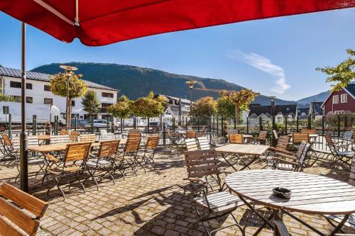 a group of tables and chairs and an umbrella at Best Western Laegreid Hotell in Sogndal