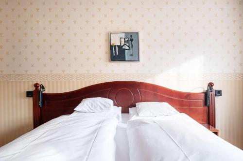 a bed with two white pillows in a bedroom at Best Western Laegreid Hotell in Sogndal