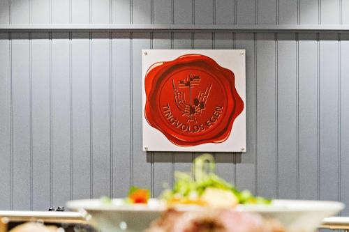 a sign hanging on a wall with plates of food at Best Western Tingvold Park Hotel in Steinkjer