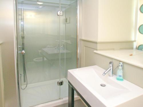 a bathroom with a shower and a sink at The Bothy House in Berwick Hill