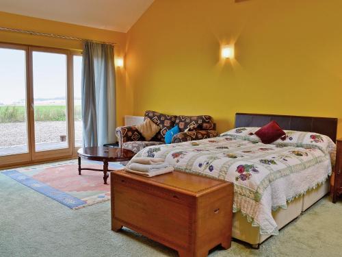 a bedroom with a bed and a couch at The Water Tower in Auchmithie