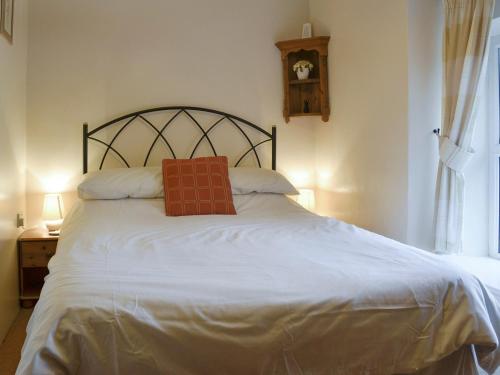 a bedroom with a bed with a book on it at 4 Tan Y Bryn Terrace in Prenteg