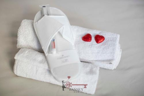 a white towel with two red hearts on it at CENTRAL & BRIGHT Apartment on two floors 'TURQUOISE' -By EasyLife Swiss in Lugano