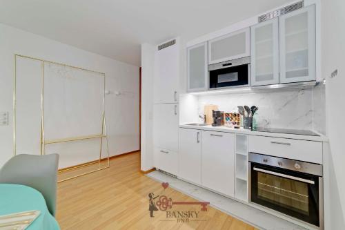 a kitchen with white cabinets and a fireplace at CENTRAL & BRIGHT Apartment on two floors 'TURQUOISE' -By EasyLife Swiss in Lugano