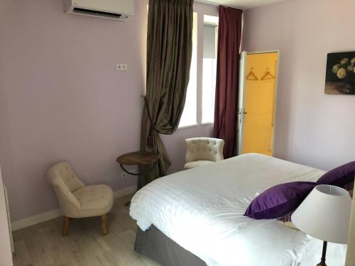 a bedroom with a bed and a chair and a window at Cottage du chateau for 4 people 90 M- 2 bedrooms 2 bathrooms pool in Azay-le-Rideau