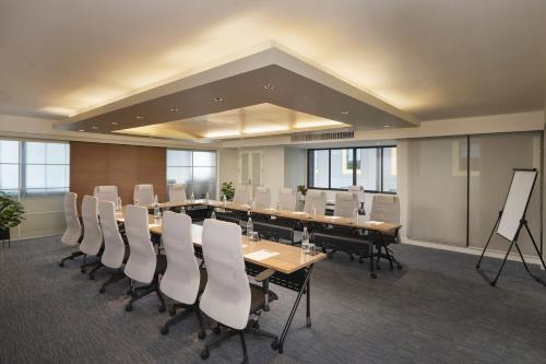 a conference room with a long table and chairs at PARKROYAL Suites Bangkok in Bangkok