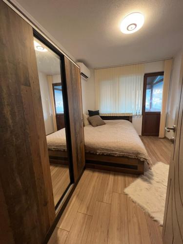a bedroom with a bed and a large mirror at Guest House Tanevi in Devin