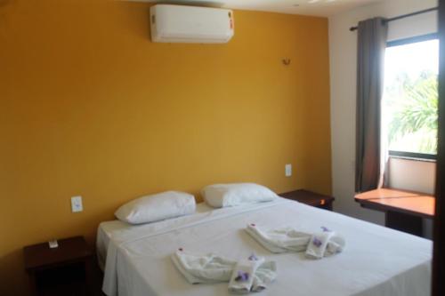 سرير أو أسرّة في غرفة في Aldeias Guajiru Apart