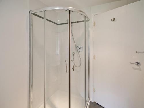 a shower with a glass door in a bathroom at The Station - E5336 in Wetheringsett