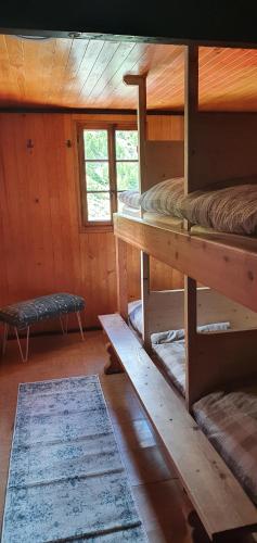 a room with two bunk beds in a cabin at Täschalp Restaurant&Lodge in Täsch