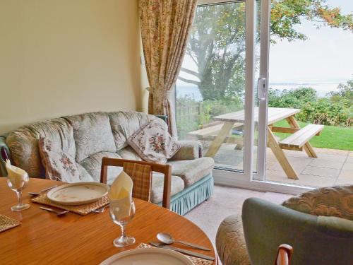 a dining room with a table and a large window at Solent View in Yarmouth