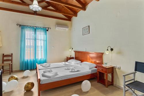a bedroom with a bed and a table and chairs at Iliopetra in Douliana