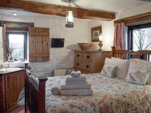 a bedroom with a bed with a teddy bear on it at The Old Sheaf Store - Kyz in Glaisdale