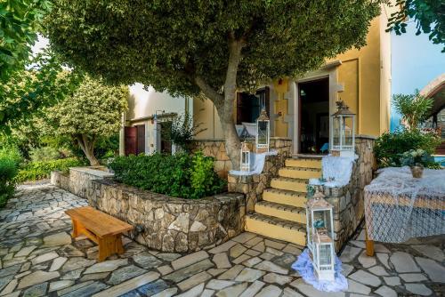 a house with a table and chairs and a tree at Iliopetra in Douliana