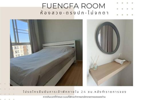 a bedroom with a bed and a mirror at Fuengfa Room in Khlong Luang