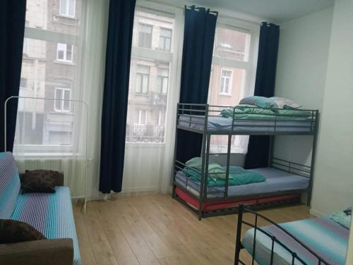 two bunk beds in a room with two windows at SUPPER Family room in Brussels