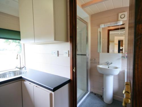 a small bathroom with a sink and a toilet at Railway Carriage One - E5337 in Wetheringsett
