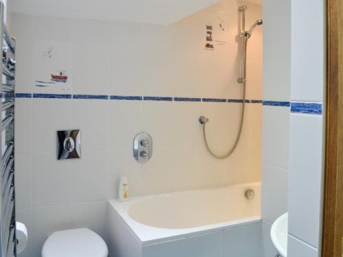 ein Bad mit einer Dusche, einem WC und einem Waschbecken in der Unterkunft The Boathouse in Findochty