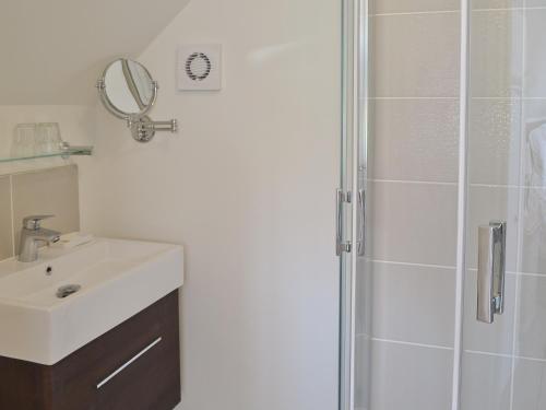 a bathroom with a sink and a shower at Coastal Retreat in Felpham