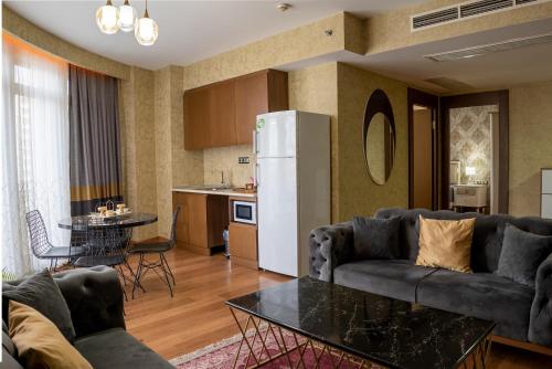 a living room with a couch and a refrigerator at My Palace Aırport in Istanbul