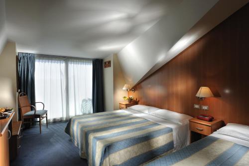 Posteľ alebo postele v izbe v ubytovaní Hotel Arizona