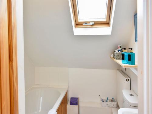 a bathroom with a tub and a toilet and a sink at Station House in Staveley