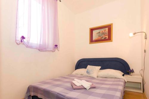 a bedroom with a bed with two towels on it at Apartments in Kraljevica 33251 in Kraljevica