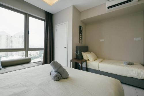 a hotel room with two beds and a window at Dorsett Hartamas KL with BathTub near MITEC MontKiara Publika in Kuala Lumpur