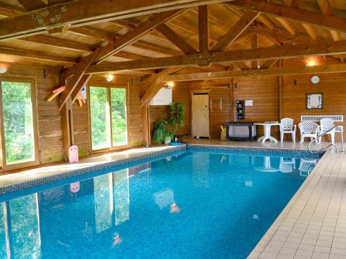 a large swimming pool in a wooden house at Glendale Cottage in Haltwhistle