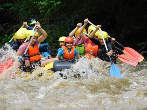 a group of people rafting on a river at Pensiunea Mireasma Bucovinei in Crucea