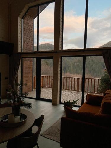 a living room with a large window with a view at ЗаҐора in Tatariv