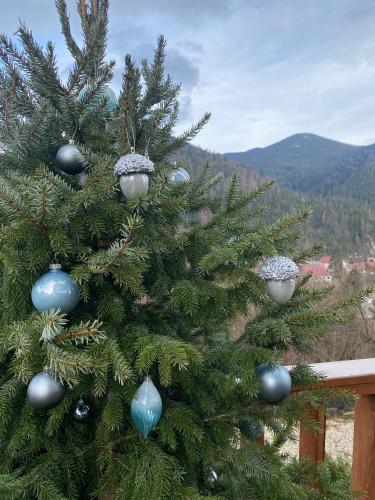 a christmas tree with blue and silver ornaments on it at ЗаҐора in Tatariv