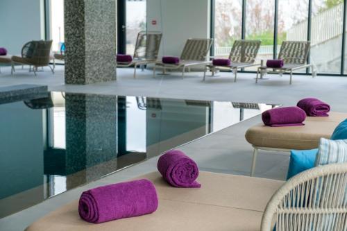 a row of chairs with purple pillows on a table at Martinhal Lisbon Oriente in Lisbon