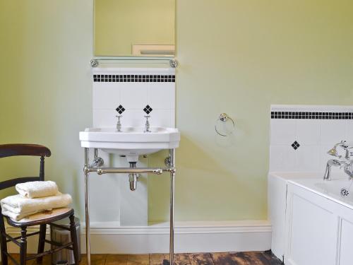 a white bathroom with a sink and a mirror at Cutcliffe Chambers - Hppr in Bideford