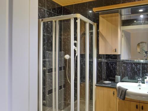 a bathroom with a shower and a sink at Golf View in Lundie