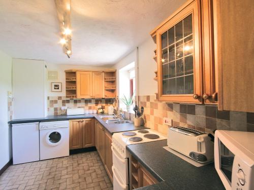 a kitchen with a washer and dryer in it at Fox Cottage - E4510 in Chipping Sodbury