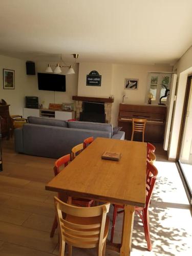 a living room with a wooden table and chairs at La Bonne Rade in Curzon