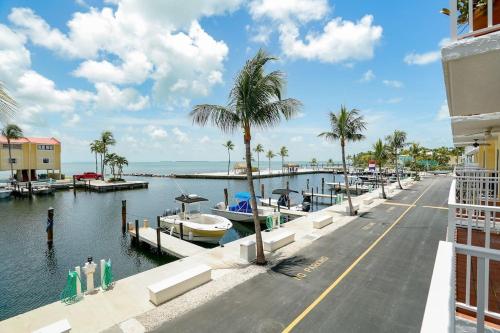 a street next to a canal with boats in the water at Islamorada Paradise Overlooking the Fabulous Florida Bay. in Tavernier
