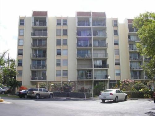 a large apartment building with cars parked in a parking lot at Islamorada Paradise Overlooking the Fabulous Florida Bay. in Tavernier