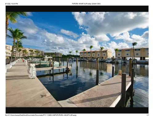 a marina with palm trees and buildings and water at Islamorada Paradise Overlooking the Fabulous Florida Bay. in Tavernier