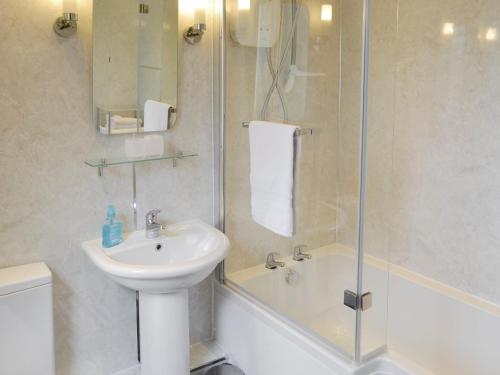 a bathroom with a sink and a toilet and a shower at Oak Cottage-16498 in Catcleugh