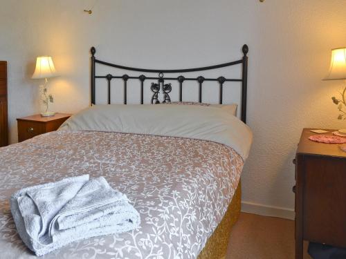 a bedroom with a bed with a towel on it at Gwenallt in Trevor