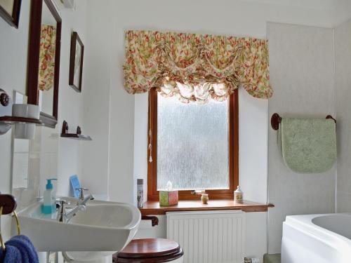 a bathroom with a sink and a window at Tigh Na Bruaich in Kenmore