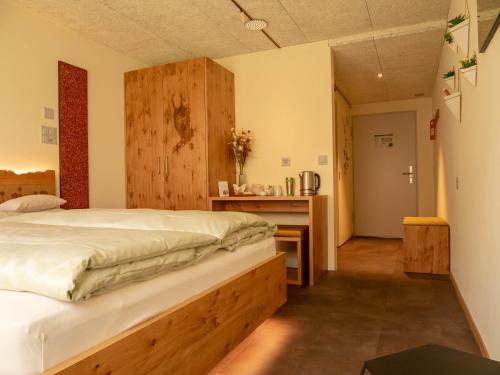 a bedroom with a large bed and a desk at The Lab Experiments in Thun