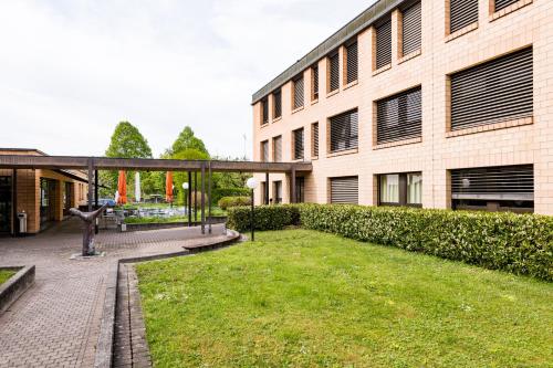 a building with a grass yard in front of a building at The Lab Experiments in Thun
