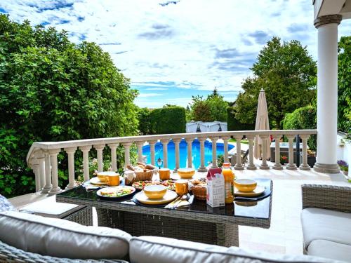 a tray of food on a table on a patio at Füge Villa Luxury & Wellness in Balatonfüred