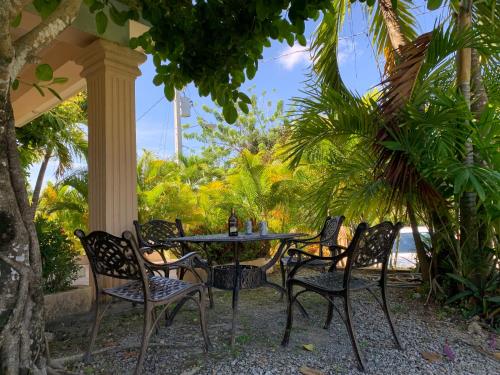 a table and chairs sitting under a porch with the ocean at Caleton Group in Río San Juan
